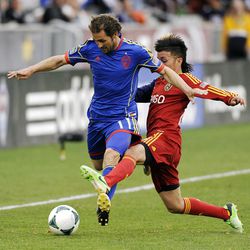 Colorado Rapids midfielder Brian Mullan, left, and Real Salt Lake midfielder Sebastian Velasquez, of Colombia, fight for the ball in the first half of an MLS soccer game in Commerce City, Colo., on Saturday, April 6, 2013. (AP Photo/Chris Schneider)