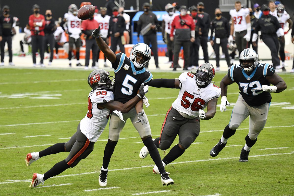 Teddy Bridgewater #5 of the Carolina Panthers is hit by Shaquil Barrett #58 of the Tampa Bay Buccaneers during their NFL game at Bank of America Stadium on November 15, 2020 in Charlotte, North Carolina.