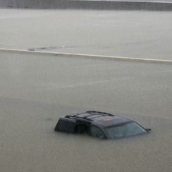 An abandoned vehicle sits in flood waters on the I-10 highway in Houston, Texas, Sunday, Aug. 27, 2017.