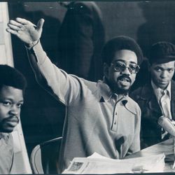 At press conference Thursday, Bobby Rush, Illinois Black Panther Party co-ordinator, denounces acquittal of Edward V. Hanrahan and 13 co-defendants. Flanking Rush are Harold Bell (left) and Ronald Satchel, tow of the seven survivors of the raid.