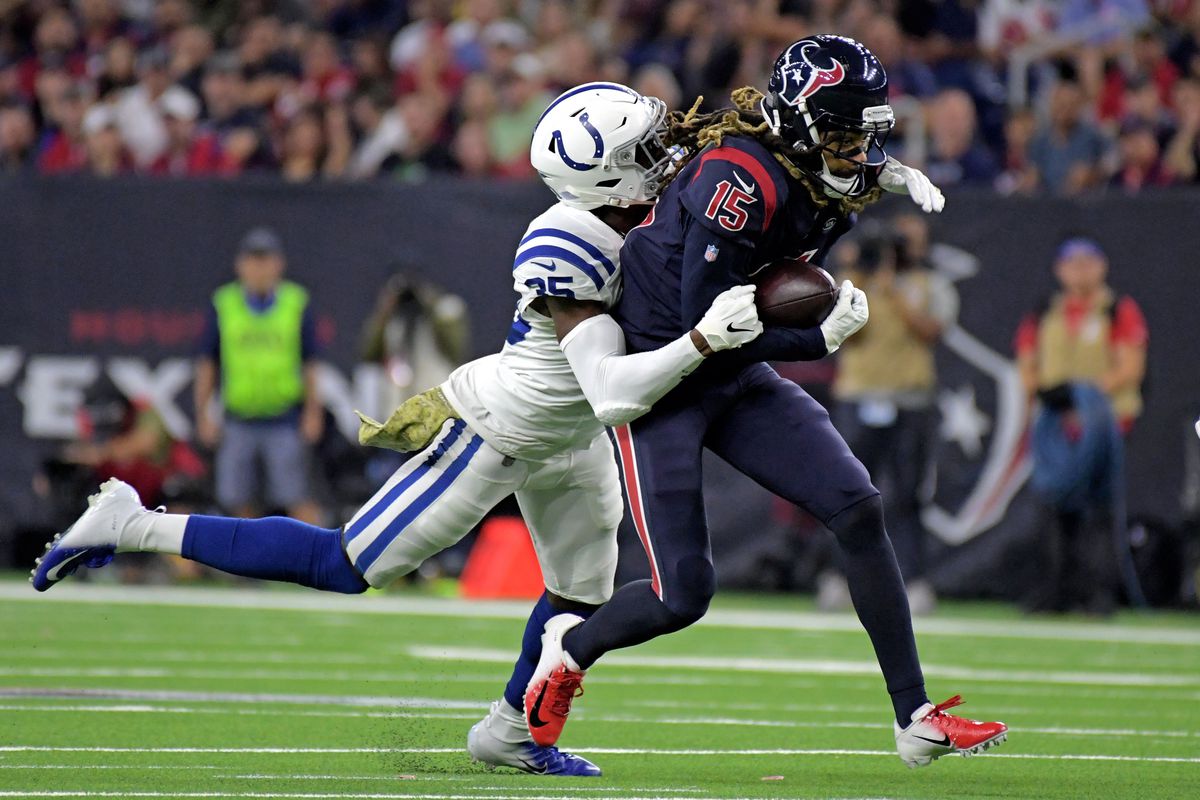 Indianapolis Colts cornerback Pierre Desir tackles Houston Texans wide receiver Will Fuller after making a catch during the first half at NRG Stadium.