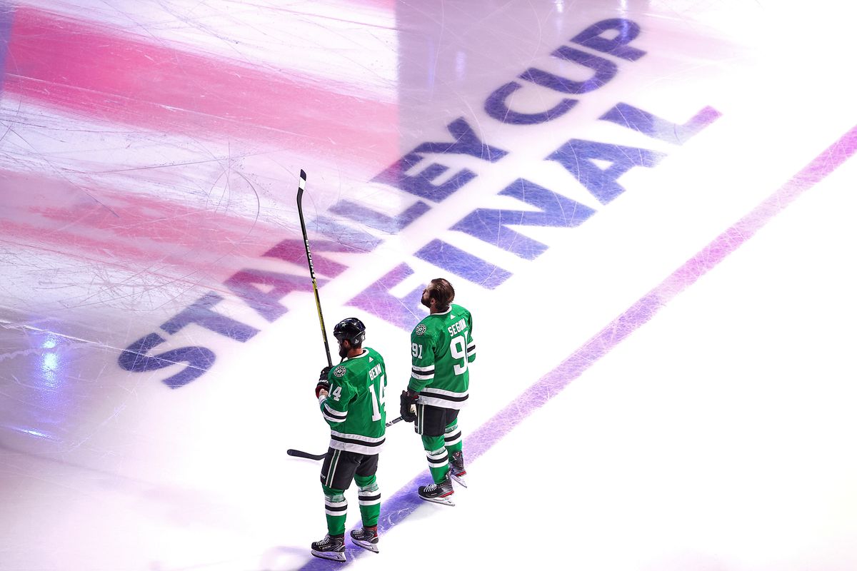 Jamie Benn and Tyler Seguin stand before the National Anthem in the Stanley Cup Final opposite the Tampa Bay Lightning.