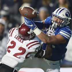 Brigham Young Cougars tight end Dallin Holker (32) tries to catch the pass under pressure from New Mexico State Aggies defensive back Shamad Lomax (22) in Provo on Saturday, Nov. 17, 2018.
