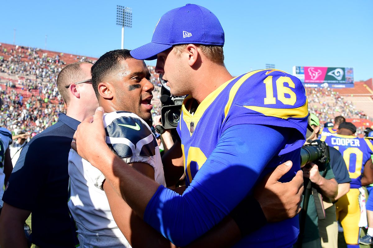 Russell Wilson of the Seattle Seahawks meets Jared Goff of the Los Angeles Rams after a 16-10 Seahawks win at Los Angeles Memorial Coliseum on October 8, 2017 in Los Angeles, California.
