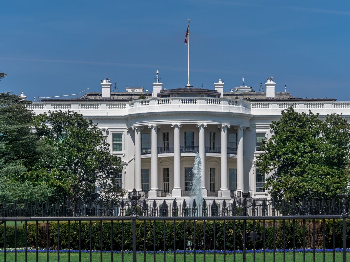 The exterior of the White House in Washington D.C. The building has columns flanking the entrance area.