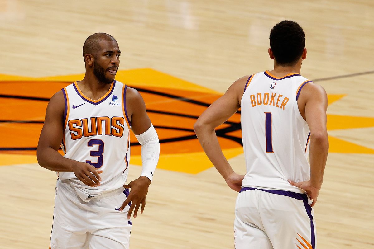 Chris Paul and Devin Booker of the Phoenix Suns during the NBA game against the Dallas Mavericks at PHX Arena on December 23, 2020 in Phoenix, Arizona. The Suns defeated the Mavericks 106-102.&nbsp;