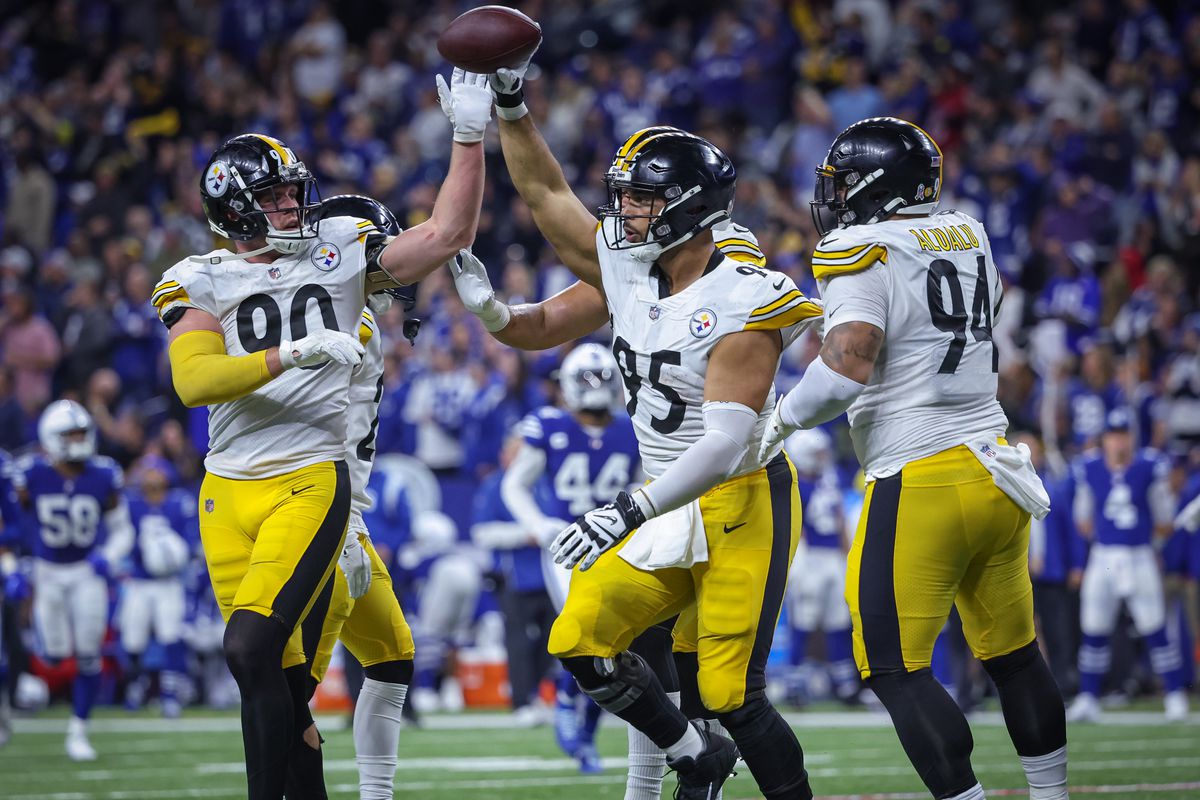T.J. Watt #90 and Chris Wormley #95 of the Pittsburgh Steelers celebrate during the game against the Indianapolis Colts at Lucas Oil Stadium on November 28, 2022 in Indianapolis, Indiana.
