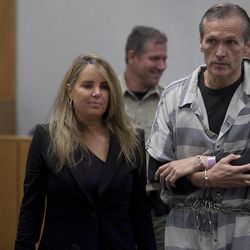 Martin MacNeill speaks with his attorney Susanne Gustin upon entering the courtroom after a recess during a preliminary hearing at the Fourth District Court in Provo Wednesday, Oct. 10, 2012. 