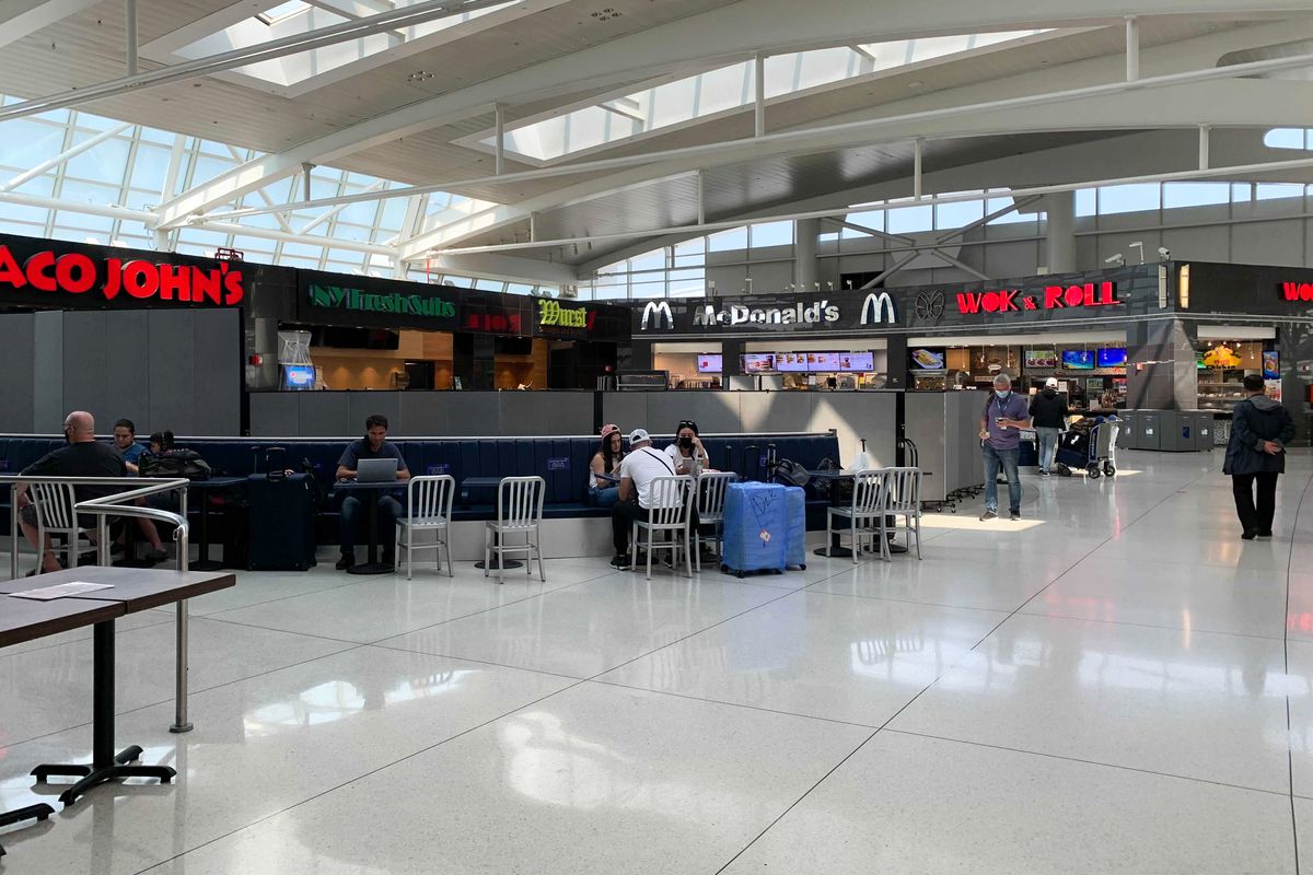 People eat at JFK Airport’s Terminal 1, July 27, 2021.