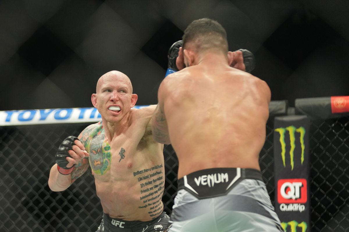 Josh Emmett punches Dan Ige in their featherweight fight during the UFC 269 on December 11, 2021, at T-Mobile Arena in Las Vegas, NV.