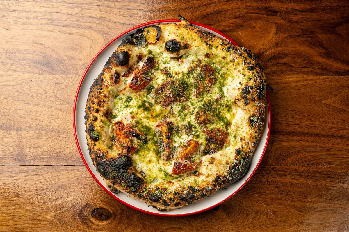 The Ode to Pepe, with mozzarella, scamorza, tomato confit, and pesto powder on a red-lined plate at Best Bet.