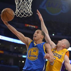 Golden State Warriors guard Stephen Curry, left, puts up a shot as Los Angeles Lakers guard Steve Blake defends during the second half of their NBA basketball game, Friday, April 12, 2013, in Los Angeles. The Lakers won 118-116. (AP Photo/Mark J. Terrill)