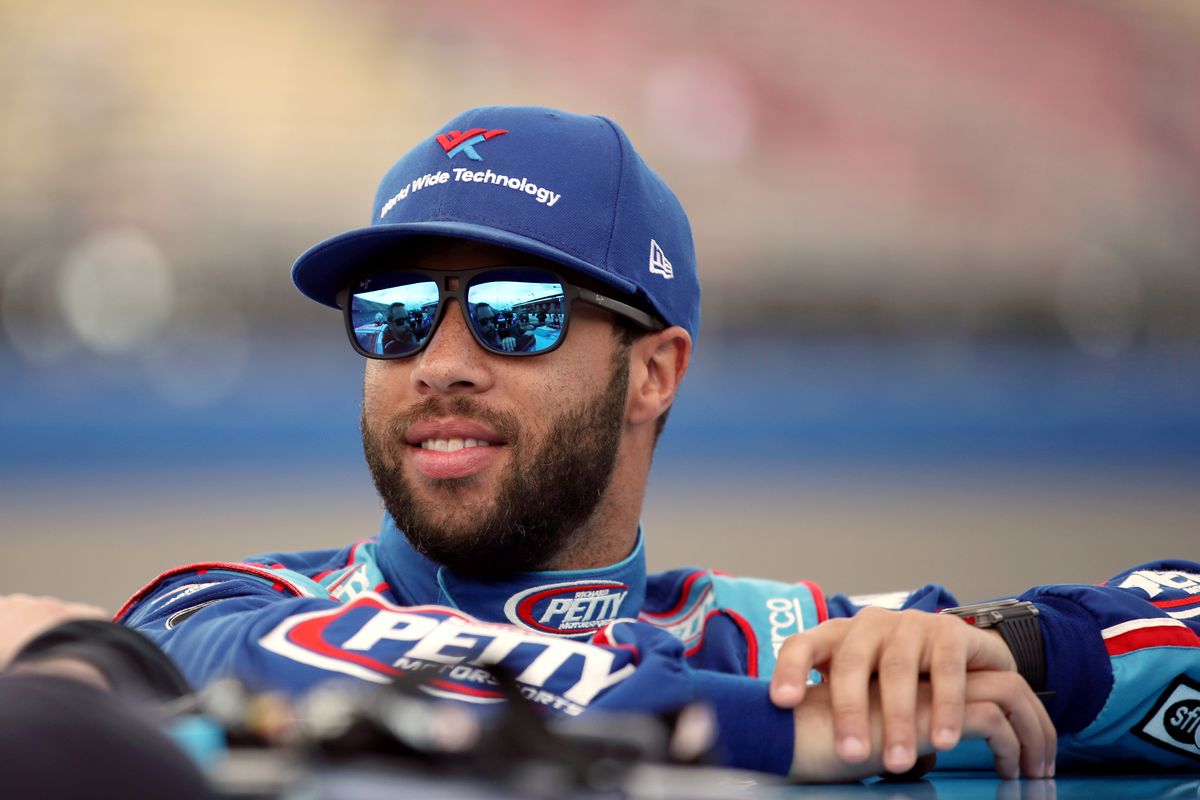 Bubba Wallace, driver of the #43 Victory Junction Chevrolet, stands by his car before qualifying for the NASCAR Cup Series Auto Club 400 at Auto Club Speedway on February 29, 2020 in Fontana, California.
