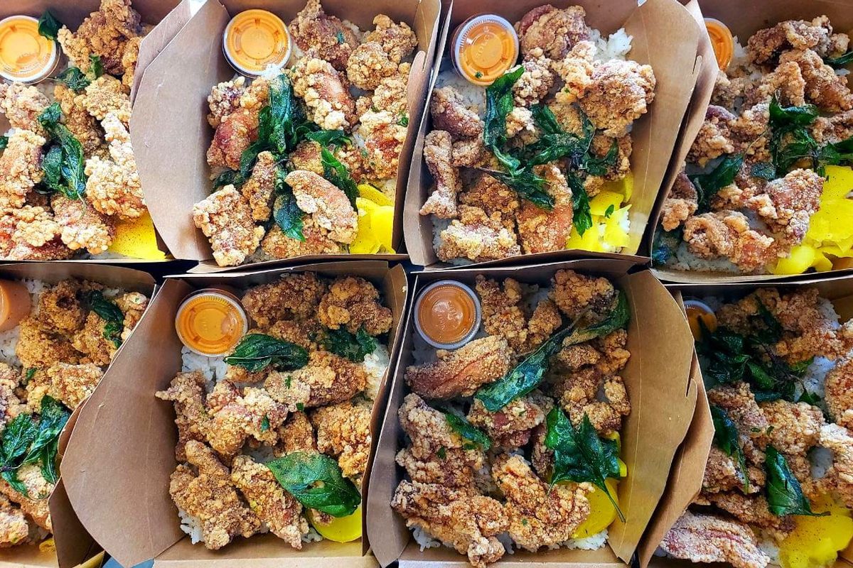 Cardboard boxes full of fried chicken.