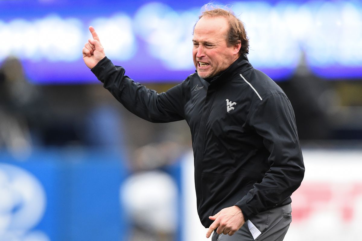 West Virginia head coach Dana Holgorsen reacts to the end of happy hour at a Morgantown Applebee's. 