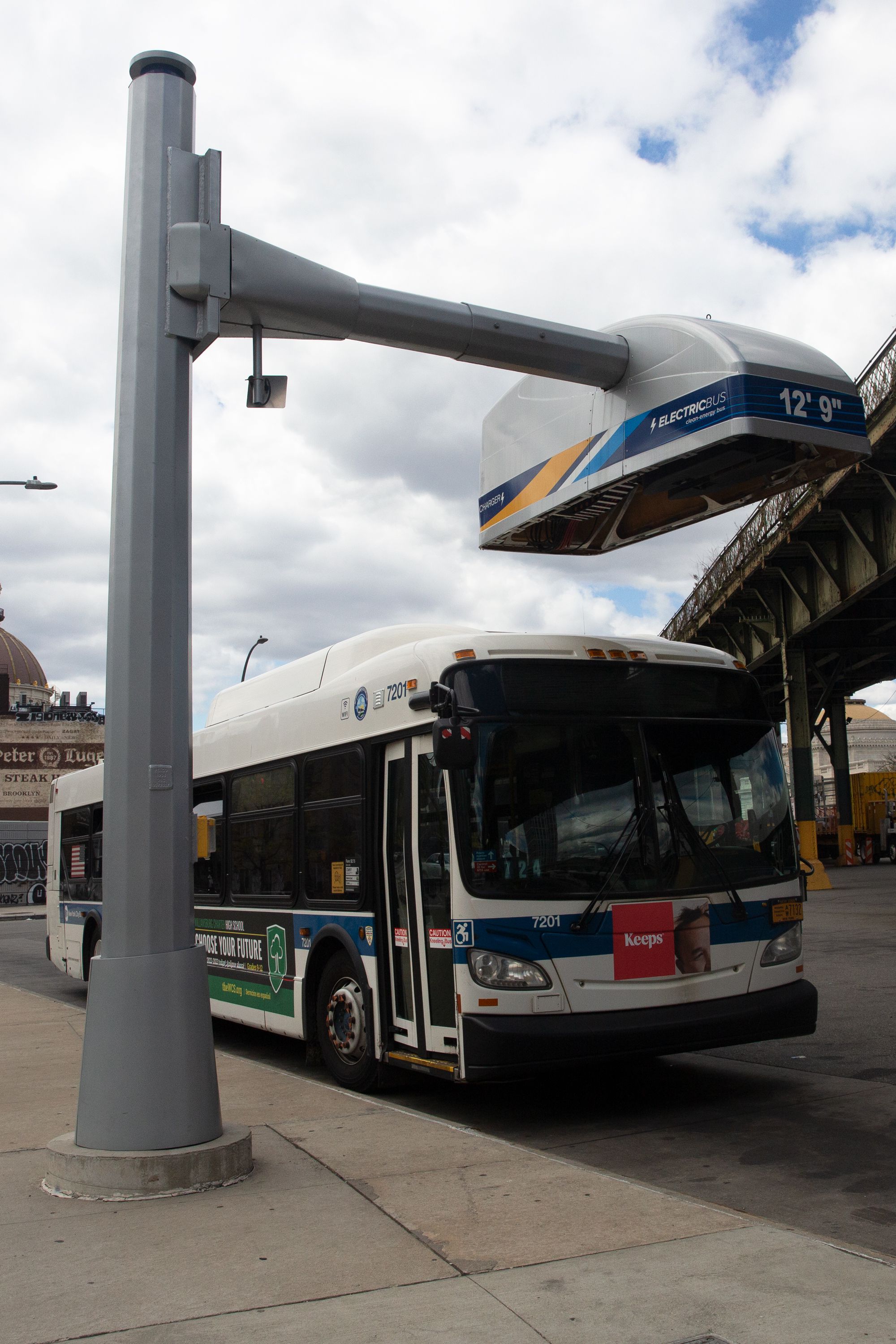 An electric bus charger was stationed at the Williamsburg bus depot, April 27, 2022.
