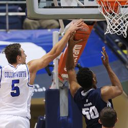 Brigham Young Cougars guard Kyle Collinsworth (5) blocks a shot by Utah State Aggies forward Elston Jones (50) as BYU and Utah State play at the Marriott Center in Provo Wednesday, Dec. 9, 2015.