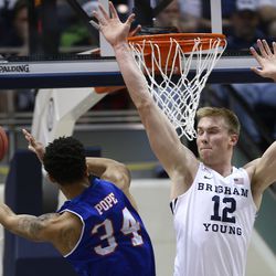 Brigham Young Cougars forward Eric Mika (12) defends Texas-Arlington Mavericks forward Faith Pope (34) as BYU and University of Texas at Arlington play in NIT basketball action at the Marriott Center in Provo Utah on Wednesday, March 15, 2017.