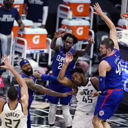 Utah Jazz guard Donovan Mitchell (45) passes to center Rudy Gobert (27) during the second half of the team’s NBA basketball game against the Los Angeles Clippers on Wednesday, Feb. 17, 2021, in Los Angeles. 