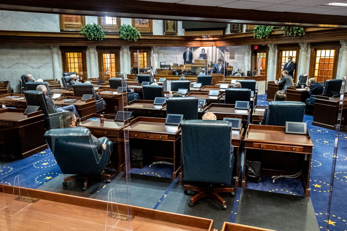 Lawmakers socially distance using the floor and balcony in the Indiana Senate chamber on Organization Day at the Indiana Statehouse.
