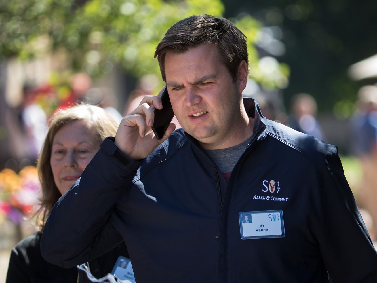 J.D. Vance holding a phone to his ear.
