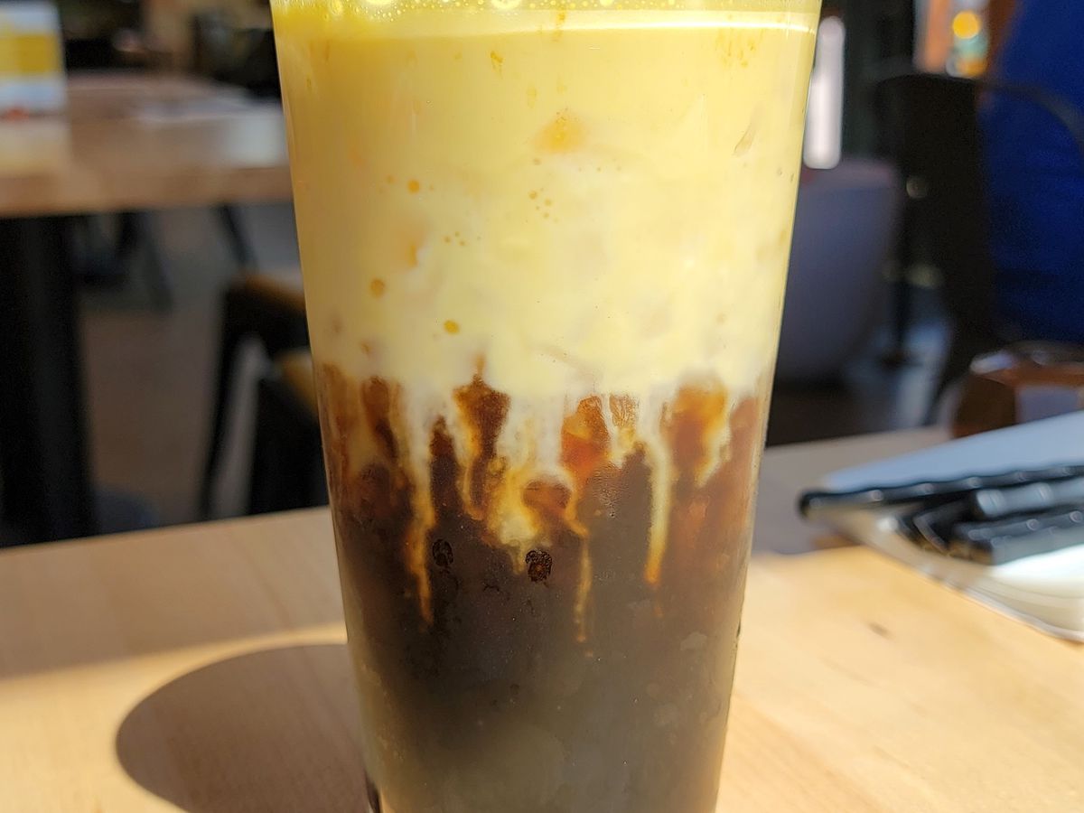 A thick layer of egg custard drips into a base of iced coffee at Lua in Portland.