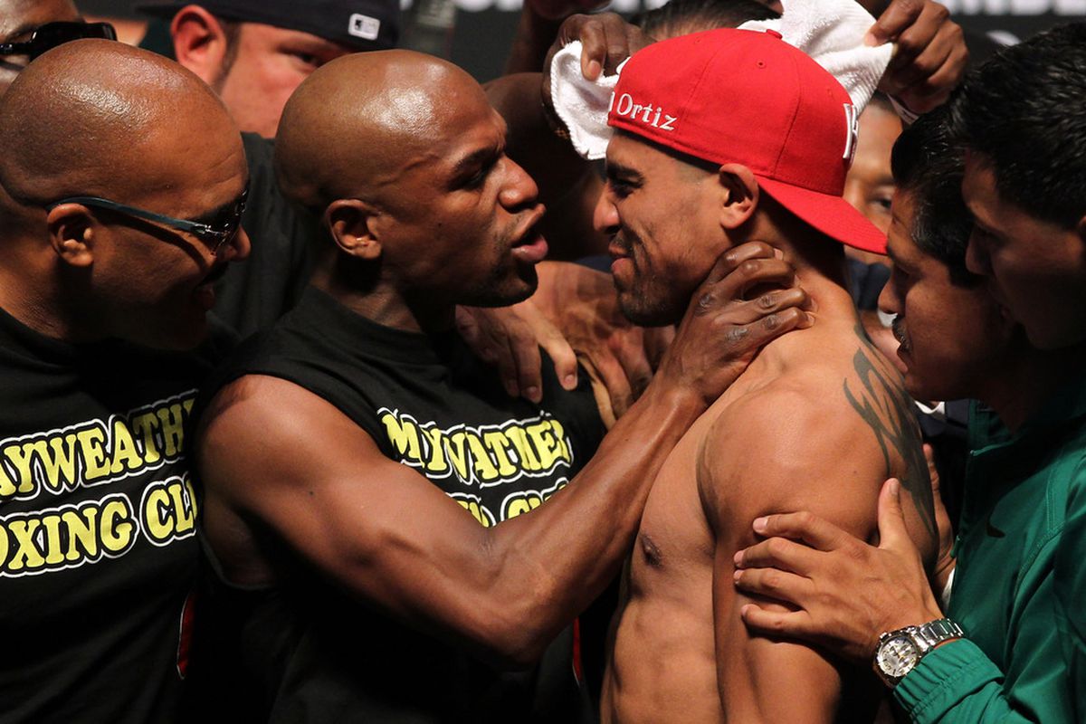 Here we see Floyd Mayweather actually choking Victor Ortiz at last September's weigh-in before their fight. This has nothing to do with why Mayweather has to have a new license hearing. (Photo by Al Bello/Getty Images)