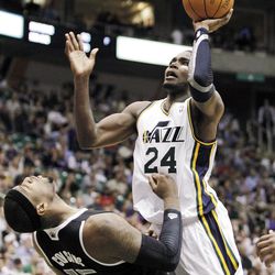 Utah Jazz forward Paul Millsap (24) is fouled by Sacramento Kings center DeMarcus Cousins (15)  as he goes to the basket during the second half of their NBA basketball game in Salt Lake City, Friday, March 30, 2012. The Kings won 104-103. (AP Photo/Steve C. Wilson)