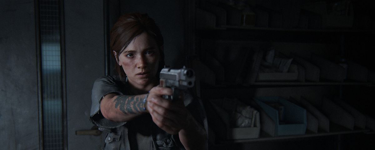 Ellie in The Last of Us 2 pointing a gun toward the camera.