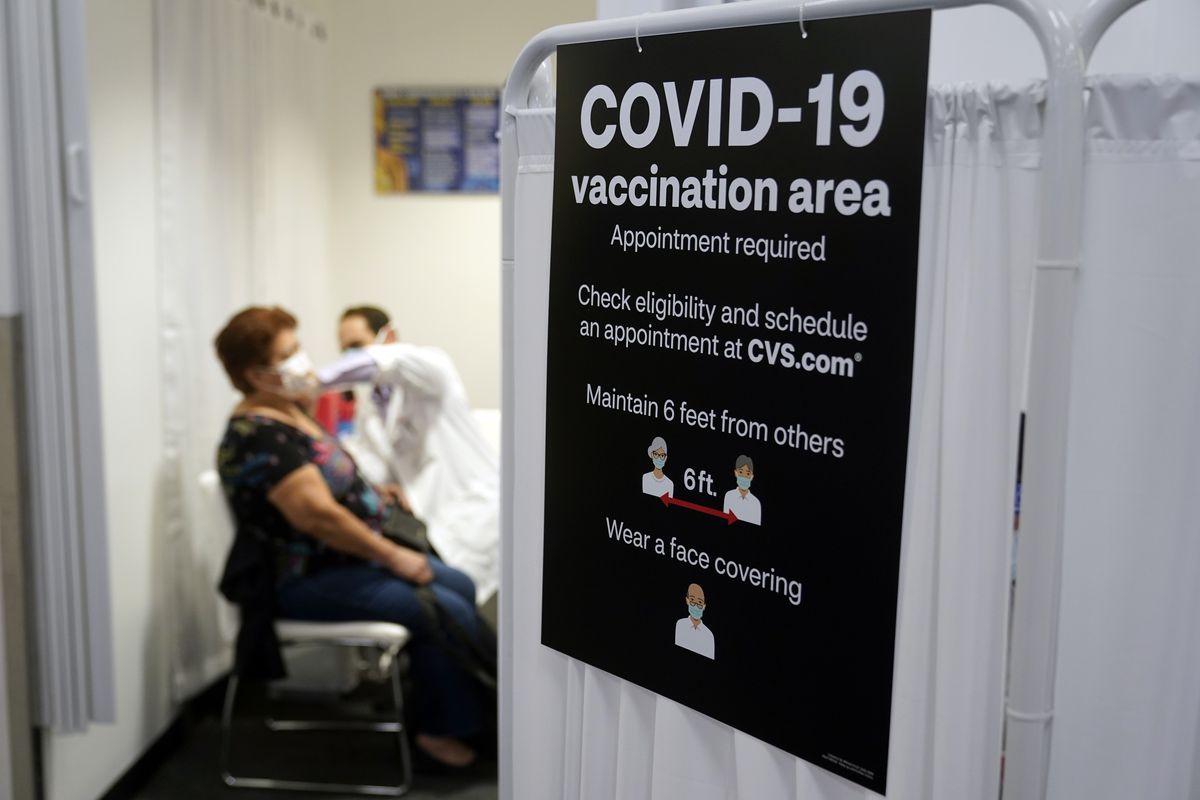 A patient gets a COVID-19 vaccine at a CVS pharmacy in Los Angeles.