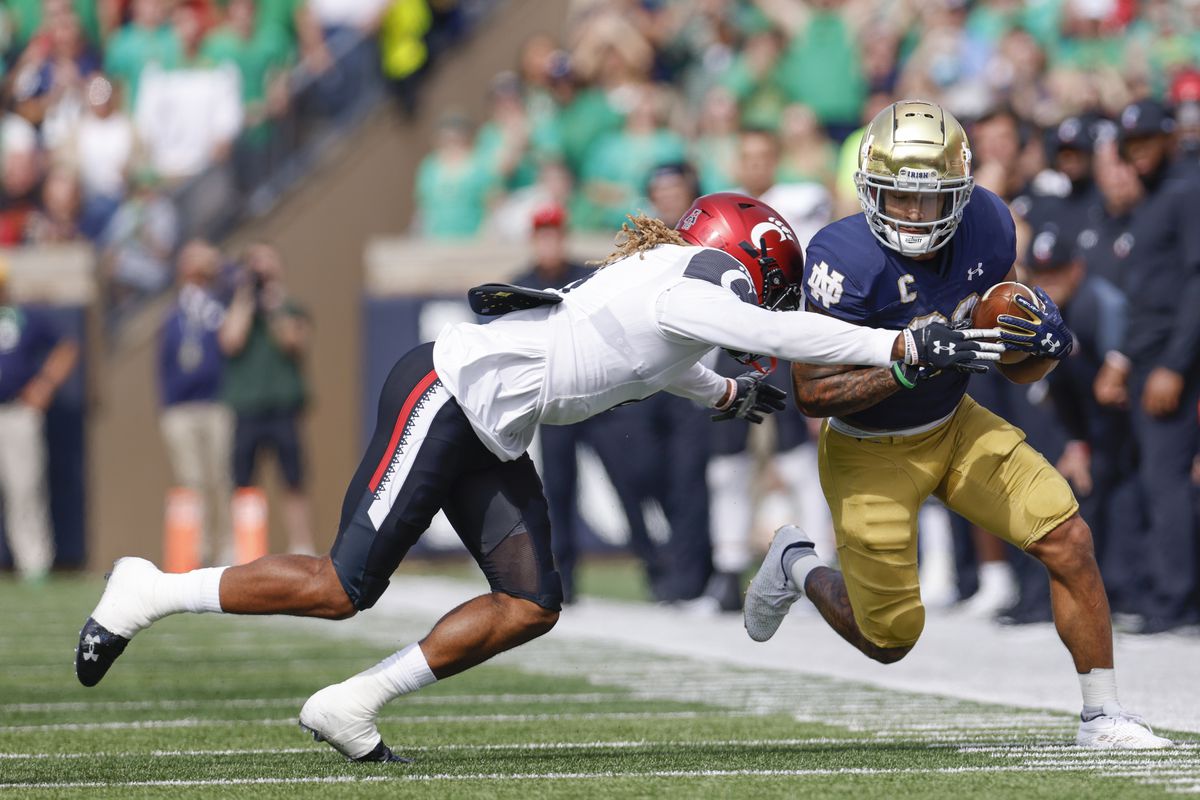 Bryan Cook #6 of the Cincinnati Bearcats makes the hit on Kyren Williams #23 of the Notre Dame Fighting Irish during the first half at Notre Dame Stadium on October 2, 2021 in South Bend, Indiana.