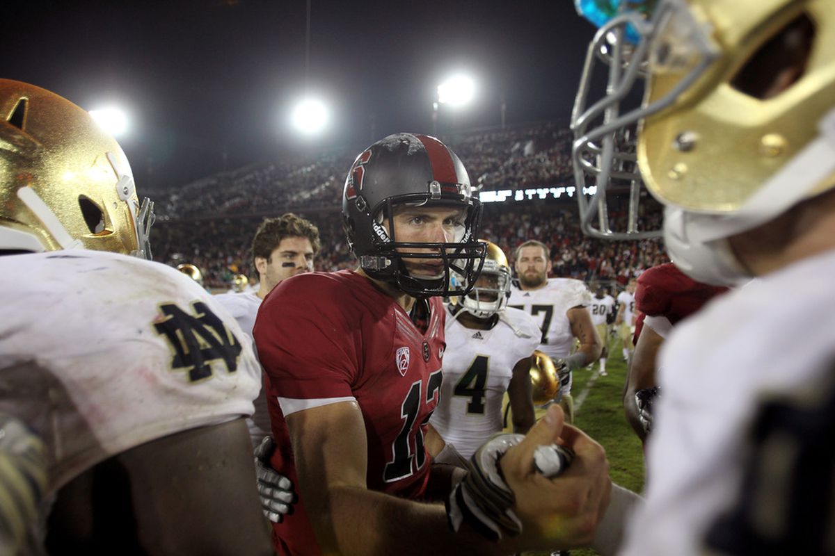 STANFORD, CA - NOVEMBER 26:  Andrew Luck #12 of the Stanford Cardinal shakes hands with players from the Notre Dame Fighting Irish after their game at Stanford Stadium on November 26, 2011 in Stanford, California.  (Photo by Ezra Shaw/Getty Images)