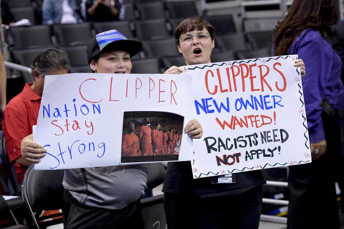 Fans hold up signs in support of the Los Angeles Clippers before Game 5 of an opening-round NBA basketball playoff series between the Clippers and the Golden State Warriors on Tuesday, April 29, 2014, in Los Angeles. NBA Commissioner Adam Silver announced