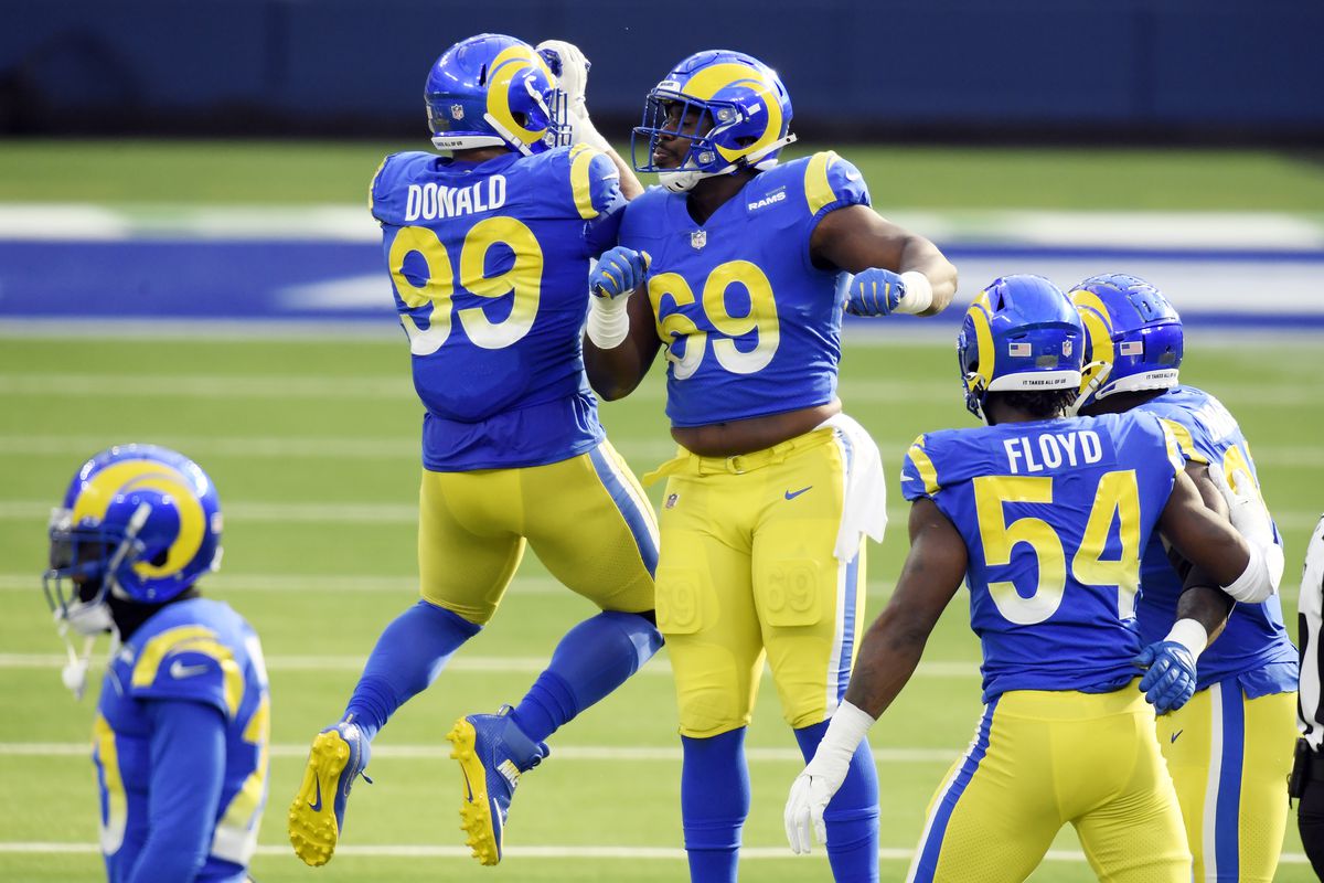 Sebastian Joseph-Day #69 of the Los Angeles Rams celebrates with Aaron Donald #99 after forcing a fumble during the first quarter against the San Francisco 49ers at SoFi Stadium on November 29, 2020 in Inglewood, California.