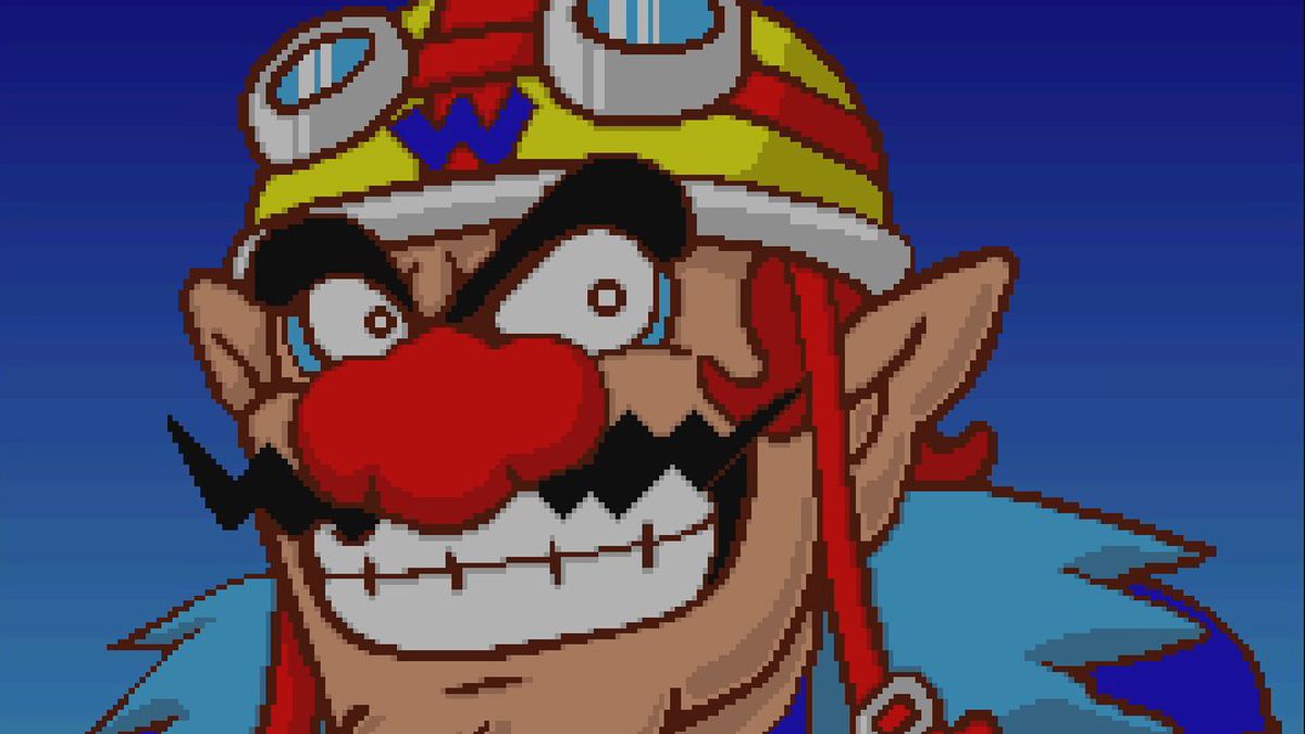 Wario’s grinning, pixelated face, with his red nose, wearing a motorcycle helmet with goggles