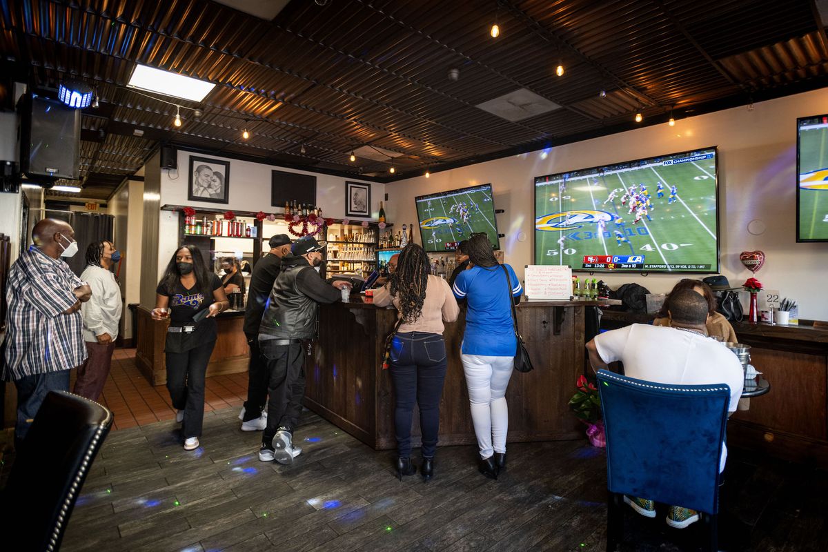 The inside of a sports bar during an LA Rams game.
