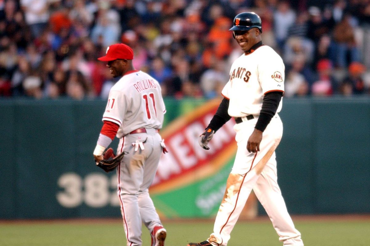 Barry Bonds of the San Francisco Giants giggles after stealing his 2nd base of the year in the 4th inning against the Philadelphia Phillies July 14, 2006 at AT&amp;T Park in San Francisco, Calif. Phillies shortstop Jimmy Rollins smiles, too. (Karl Mondon/Cont