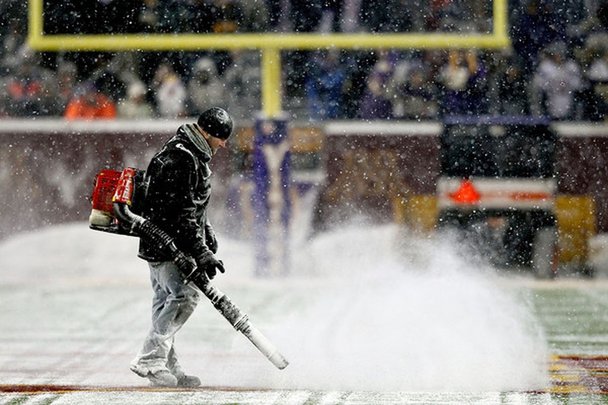 Workers clear snow from the field before Minnesota Vikings play the Chicago Bears at TCF Bank Stadium in Minneapolis Minnesota.  (Photo by Matthew Stockman/Getty Images)