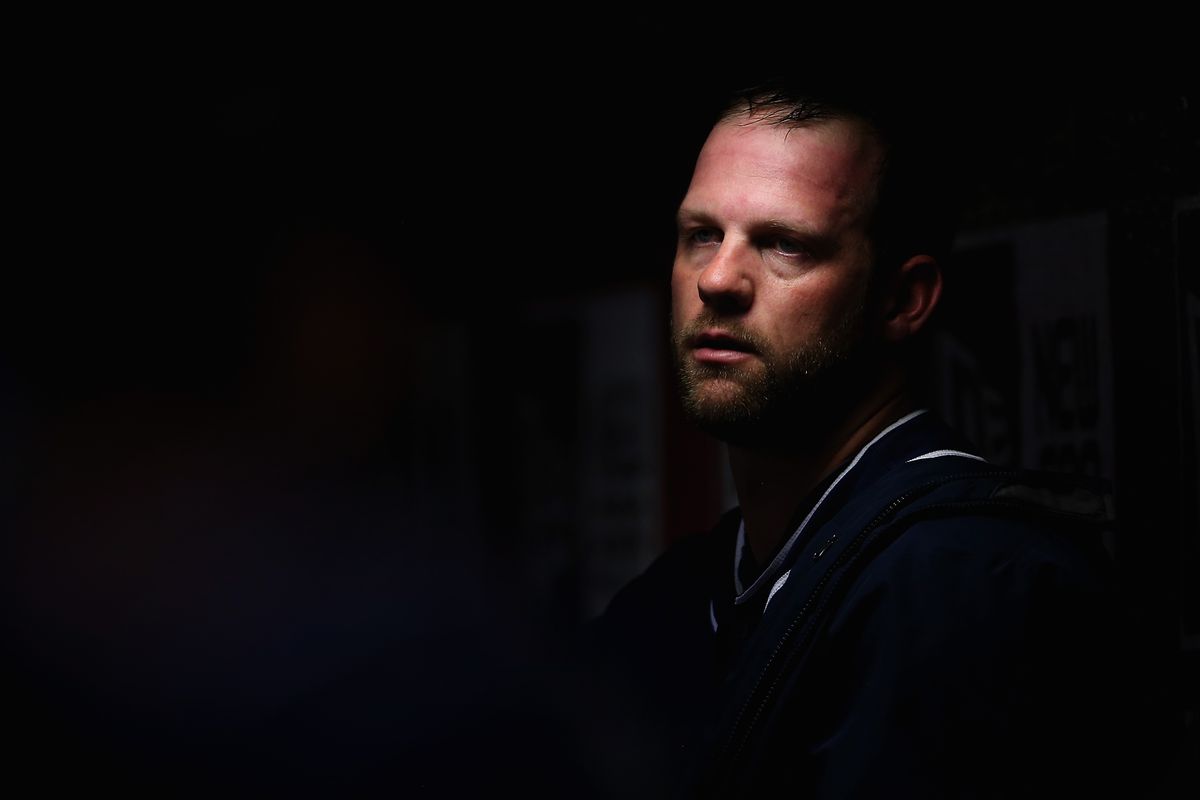 Eric Stults lurks in the total darkness engulfing the Padres dugout.