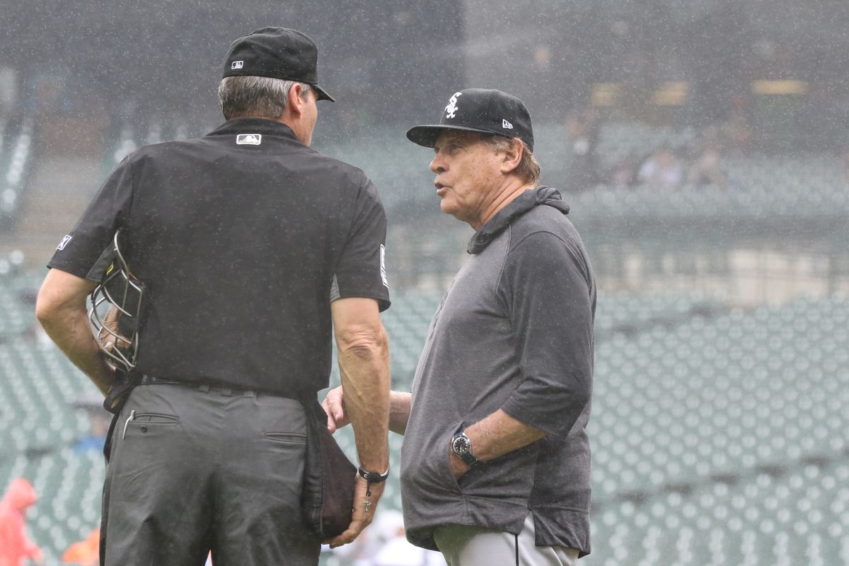 Chicago White Sox manager Tony La Russa (22) talks with home plate umpire Angel Hernandez while a steady rain falls during the third inning of a regular season Major League Baseball game between the Chicago White Sox and the Detroit Tigers on September 21, 2021 at Comerica Park in Detroit, Michigan.