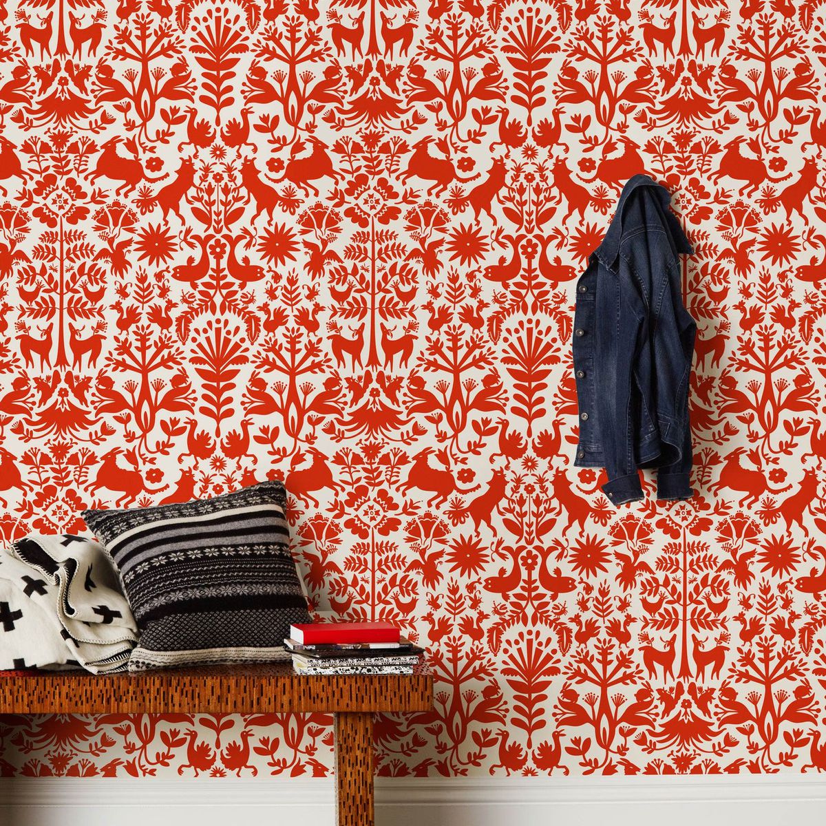 Red wallpaper in a pattern featuring botanicals, flowers, and animals