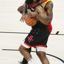 Utah Jazz forward Royce O'Neale (23) fouls Houston Rockets guard James Harden (13) during the NBA playoffs in Salt Lake City on Saturday, April 20, 2019. The Jazz lost 104-101.