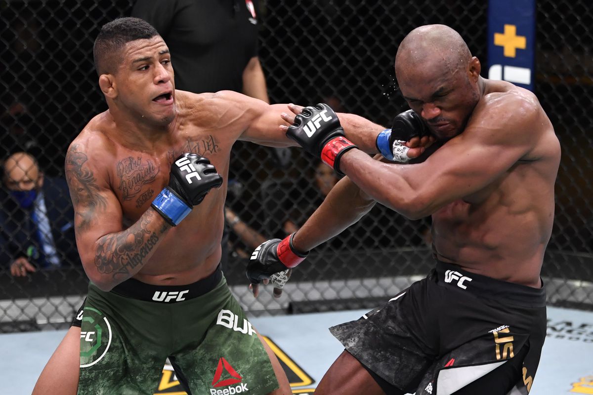 In this handout image provided by UFC, Gilbert Burns of Brazil punches Kamaru Usman of Nigeria in their UFC welterweight championship fight during the UFC 258 event at UFC APEX on February 13, 2021 in Las Vegas, Nevada.