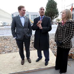 Salt Lake County Mayor Ben McAdams, left, District Attorney Sim Gill, center, and Salt Lake County councilwoman Aimee Winder Newton chat before signing the last steel beam before it is raised into place atop the new district attorney office building in Salt Lake City on Tuesday, Dec. 6, 2016.
