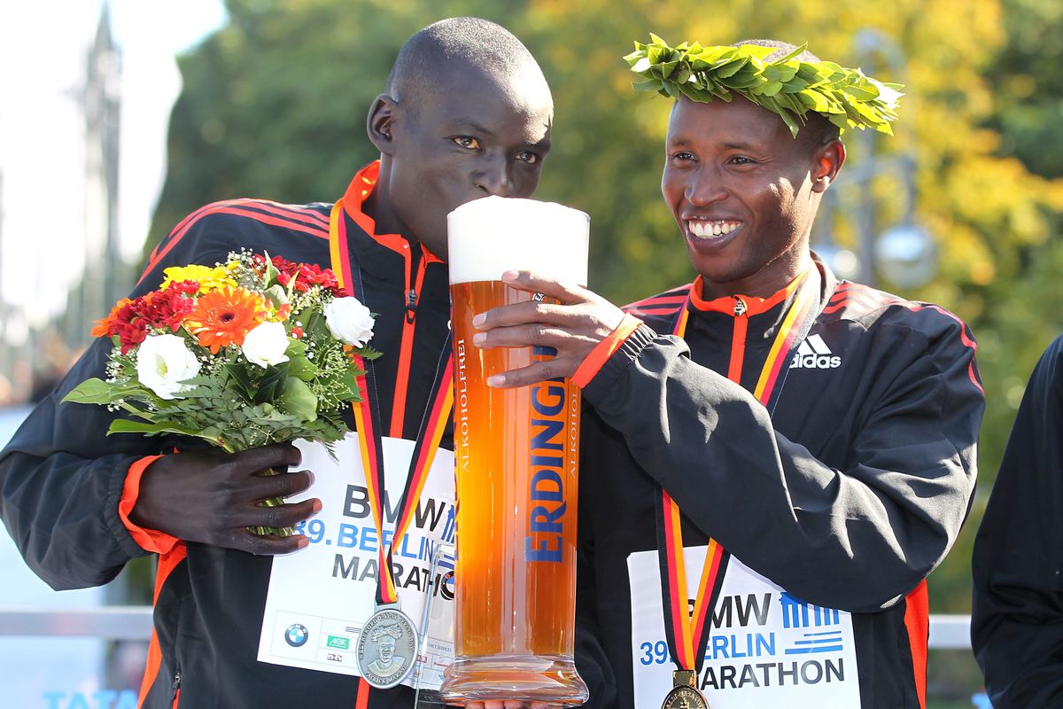 BERLIN, GERMANY - SEPTEMBER 30: Geoffrey Mutai (R) of Kenya and Dennis Kimetto (L) of Kenya drink a beer after the 39th Berlin Marathon on September 30, 2012 in Berlin, Germany. (Photo by Matthias Kern/Bongarts/Getty Images)