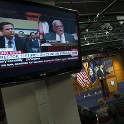 FILE - In this July 7, 2016 file photo, a television monitor shows House Oversight and Government Reform Committee member Rep. Gerry Connolly, D-Va., right, questioning FBI Director James Comey, as House Speaker Paul Ryan of Wis. speaks during a news conference on Capitol Hill in Washington. Comey, who prides himself on moral rectitude and a squeaky-clean reputation is being criticized from all sides for lobbing a stink bomb into the center of the presidential race. Former Justice Department officials and former prosecutors from both parties have called the revelation an improper, astonishing and perplexing intrusion into politics in the critical endgame of the 2016 campaign.