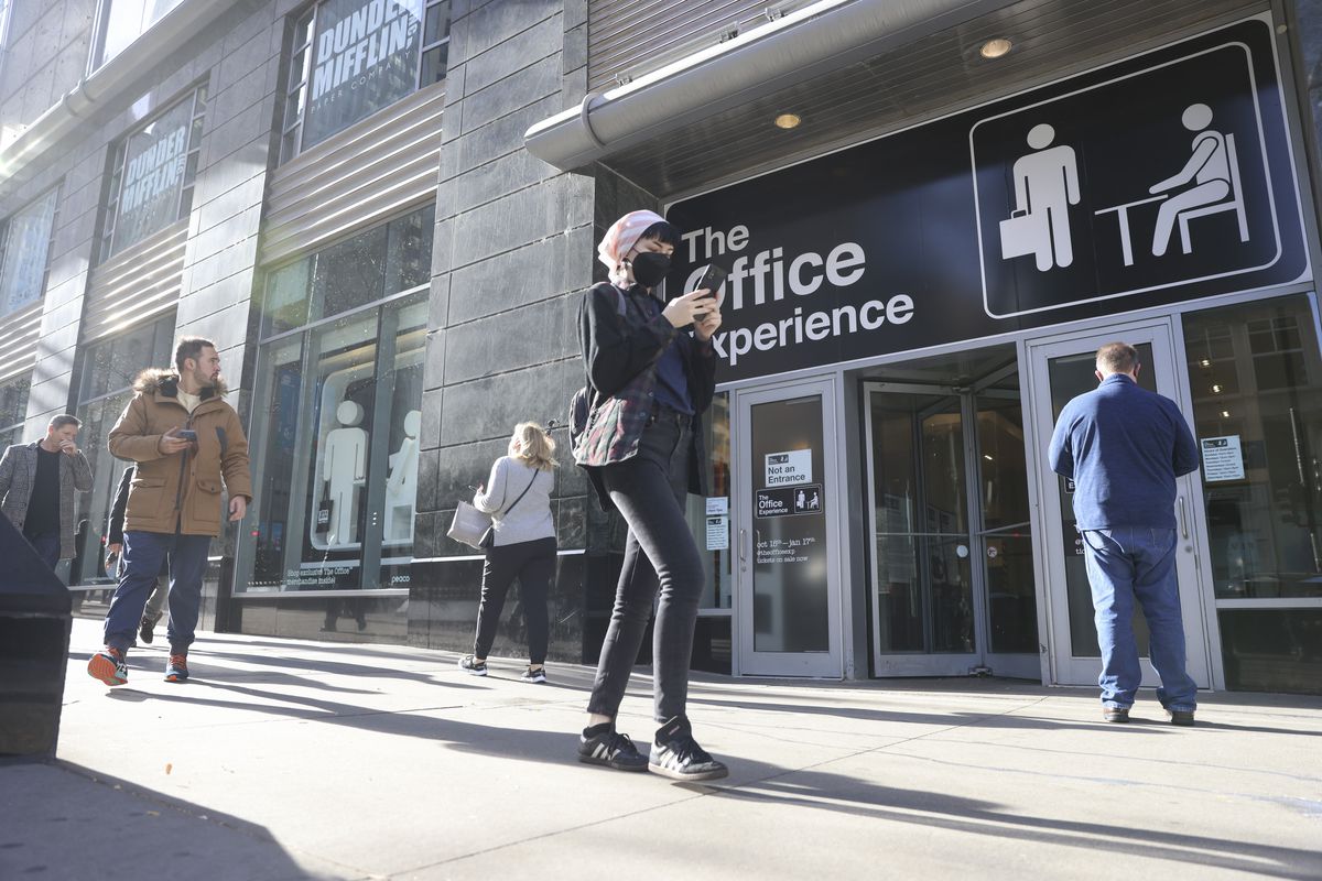 Pedestrians pass The Office Experience at 540 N. Michigan Ave., an example of attractions that temporarily have taken up the slack from retailers that have left the street.