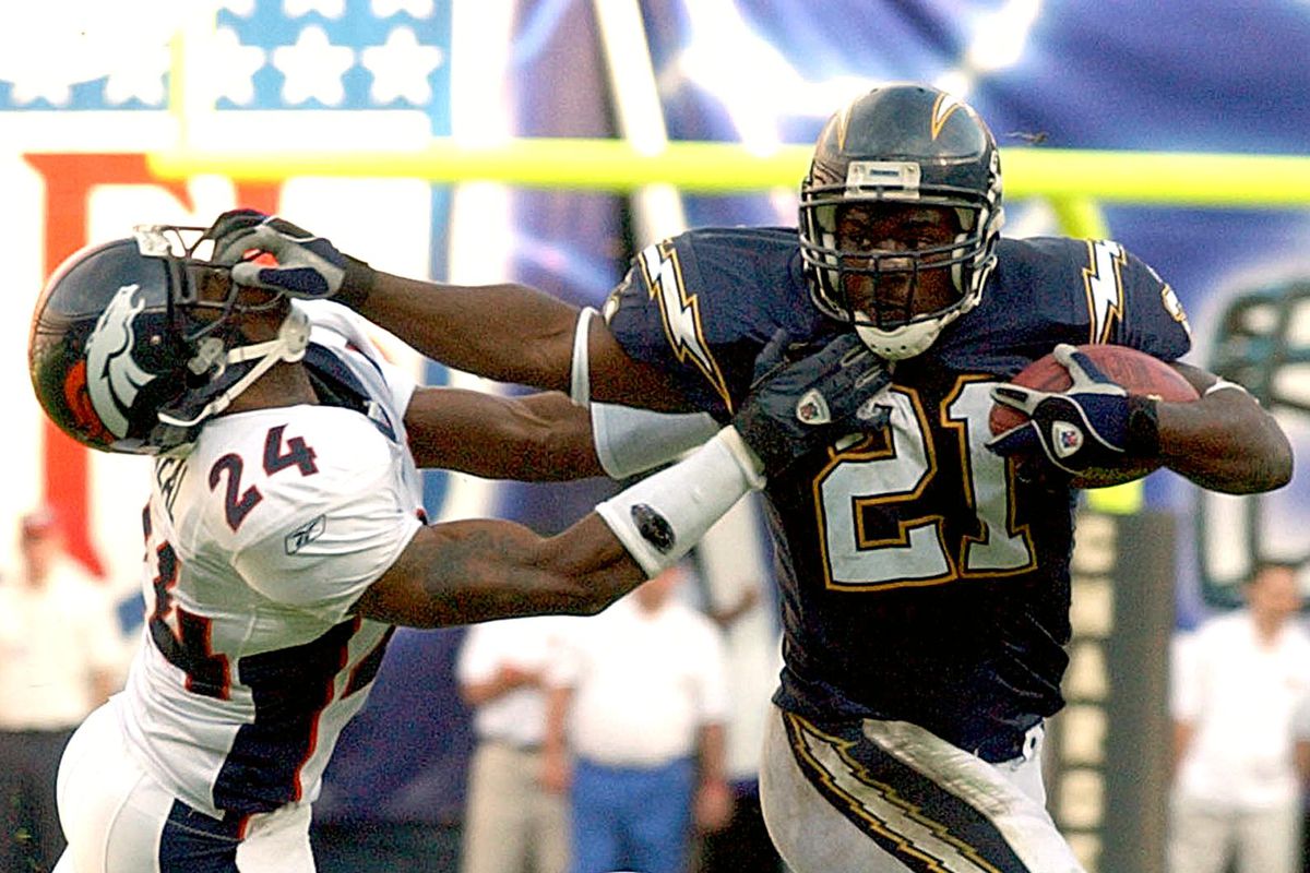 San Diego Charger LaDainian Tomlinson (R) fends of