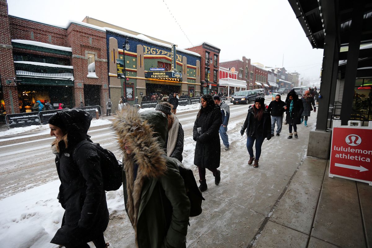 People walk the sidewalks on Main Street in Park City as they attend Sundance on Sunday, Jan., 22, 2017.
