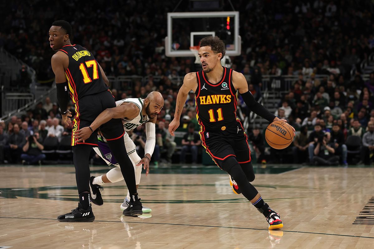 Trae Young #11 of the Atlanta Hawks drives around a pick set by Onyeka Okongwu #17 during a game against the Milwaukee Bucks at Fiserv Forum on March 09, 2022 in Milwaukee, Wisconsin.